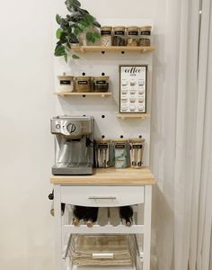 a small kitchen island with shelves on the wall above it and an espresso machine