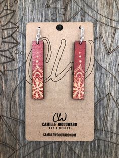 the earrings are made out of wood and have floral designs on them