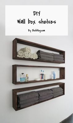 three wooden shelves with towels and other items on them