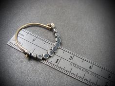 "These delicate 14k gold filled hoops have been hand formed and connect to a hammered beaded sterling silver crescent. The silver bead wire has been flatted to be wider at the bottom and given a gentle curve. The silver has been oxidized to add drama and contrast. Unique, simple and perfect for everyday. Size ~ 1\" x 3/4\" ☞ Each pair is made by hand, expect slight variation. Be sure to check out my shop to find more size options. https://www.etsy.com/shop/sirenjewels ★ Shipping ~ Domestic order Artisan Hammered Hoop Jewelry, Dainty Small Hoop Hammered Jewelry, Unique Hammered Small Hoop Jewelry, Metal Minimalist, Bead Wire, Gold Filled Hoops, Artisan Earrings, Hand Crafted Jewelry, Silver Bead