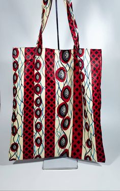 Our new line HT Collections Ankara print medium tote bags are stylish, ideal for school, University, college, shopping and weekend away. We proud ourselves with high quality 100% Cotton African print fabrics. Our bags can be wore resiverable. Height 44cm  (17 inches) Length 38cm ( 15 inches) Care Instructions Machine wash 35c Handwash is save Eco-friendly Red Shoulder Bag For Shopping, Reversible Square Shopping Bag, Red Reusable Casual Bag, Red Reusable Everyday Bag, Red Casual Reusable Bag, Red Reversible Bag For Shopping, Reversible Red Tote Shoulder Bag, Red Reversible Shopping Bag, Eco-friendly Red Shopping Bag