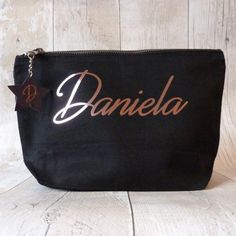 a black bag with the word danielle on it and a star hanging from the front