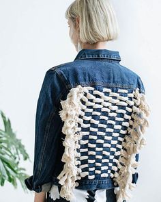 a woman with blonde hair wearing a denim jacket