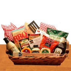 a basket filled with condiments and sauces on top of a wooden table