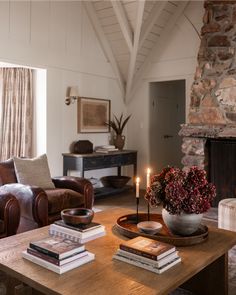 a living room filled with furniture and a fire place in front of a stone fireplace