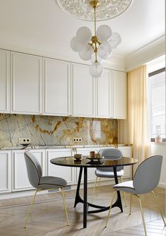 a dining room table with chairs and a chandelier hanging from the ceiling above it