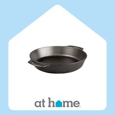 an iron skillet sitting on top of a blue and white background with the words at home above it