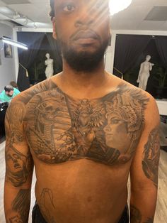 a man with many tattoos on his chest