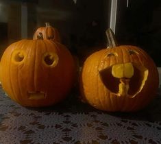 two pumpkins that have been carved to look like faces