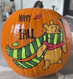 a carved pumpkin with an image of a bear on it's face and the words happy fall