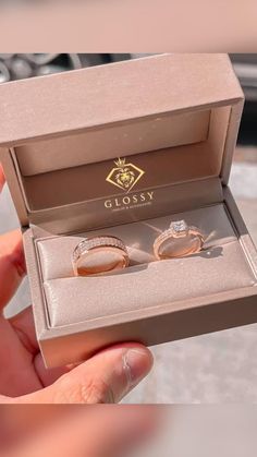 two wedding rings in a box with the lid open to show it's inside