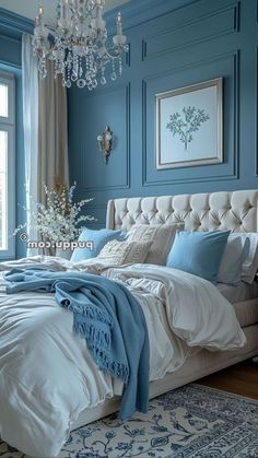 a bedroom with blue walls and chandelier hanging from the ceiling in front of a bed