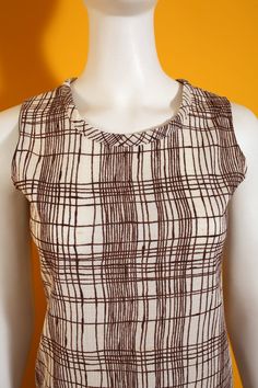 "Cool Vintage 60s 70s Brown & Off-White Hatchmark Pattern Sleeveless Top Has stretch. Bust 17\" (laid flat) Length, Top to Bottom 22\" Bottom Opening 17.5\" (laid flat) Arm Opening 7.5\" (laid flat) Tag: Size 8 / 100% Polyester / Made in California Condition: 2 Condition Scale: 1-Immaculate Vintage Condition (Rare) 2-Unnoticeable Vintage Wear or Spots that are unphotographable 3-Small Noticable Vintage Wear or Spots, as photographed 4-A Lot of Noticable Vintage Wear or Spots, as photographed Retro Fitted Sleeveless Tank Top, Fitted Retro Sleeveless Tank Top, Retro Fitted Cotton Tank Top, Fitted Retro Cotton Tank Top, Retro Brown Sleeveless Top, Retro Sleeveless Cotton Vest, Spring Sleeveless Lined Top, Retro Fitted Summer Vest, Vintage Sleeveless Brown Top