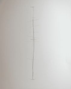 a drawing of a tall pole on a white wall