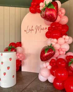 some balloons and strawberries are on display