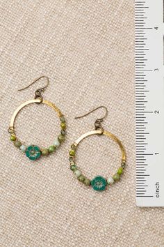 From the Czech Glass collection these charming hoop earrings are handcrafted with intricate designs and delicate colors and are sure to add a touch of whimsy and elegance to any outfit Antique Brass (lead and nickel free) Czech Glass 2", with antique plated brass ear wires We hand select our natural materials, thus there may be slight variations in color and/or size that will not detract from the overall aesthetic Our unique handcrafted designer jewelry for women is made in America, each design Bohemian Brass Flower Earrings, Bohemian Gold Hoop Earrings For Spring, Bohemian Dangle Hoop Earrings For Spring, Green Bohemian Beaded Hoop Earrings, Handmade Round Brass Flower Earrings, Green Bohemian Hoop Earrings Hypoallergenic, Bohemian Green Hoop Earrings Hypoallergenic, Nickel Free Metal Earrings For Spring, Nickel-free Hoop Jewelry For Spring