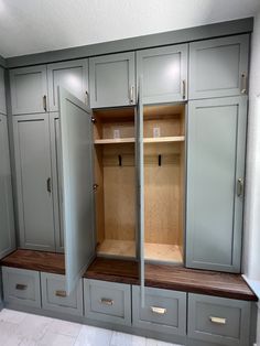 an empty walk in closet with wooden drawers