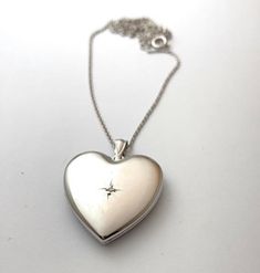 "Diamond Heart Locket in Sterling Silver, * 3/4 Inch Pendant * Holds 2 Photos * Solid 925 Sterling Silver, NOT Plated * Chain in 6 Lengths, 16\", 18\", 20\", 22\", 24\", 30\" * Gift for Women: Mother, Grandmother, Daughter, Sister, Wife, Friend * Rhodium Anti-Tarnish Coating * Comes in Gift Box with Velvet Pouch Thank you for visiting HarperSilver! 🎁Packaging: This item comes gently packaged in a fabric pouch housed inside of a silver foil linen box with a silver bow. It is ready to present as Picture Locket, Sterling Silver Locket, Photo Locket Necklace, Silver Locket, Heart Locket Necklace, Jewelry Lockets, Silver Bow, Photo Locket, Silver Lockets