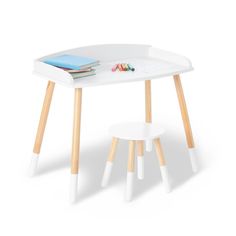 a white table with two stools and a book on top of it, in front of a white background