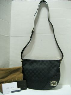 Authentic High End Designer Clothes, Handbags, Shoes, Accessories and Jewelry at Affordable Prices! Always, 100% Authentic Guarantee or 110% Money Back! Since 2001 Fast Shipping-30 Day Hassle Free Returns   New With Tags and Dust Bag Gucci Black GG Motif Logo Canvas with Black Leather Trim Half-Moon Crossbody Bag With Silvertone/Light Goldtone GG Hardware and Zip Top Closure  MADE IN ITALY Approx.  11.5"(Top) W x 9" W x 2" D Adjustable Shoulder Strap: 19" -21" Drop  This gorgeous, iconic Gucci s Bag Gucci, Gucci Models, Silver Logo, Classic Bags, Moon Design, Gucci Black, Leather Silver, Black Canvas, Medium Bags