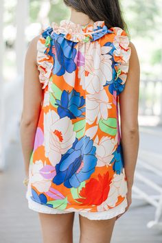 Get ready to turn heads with this bold floral tank! Featuring feminine ruffled detailing and a vibrant floral print, this tank is perfect for so many casual summer occasions. Pair it with your favorite shorts or jeans for an effortlessly chic and playful look. V-neckline Ruffled detailing Bold floral print No stretch Cindy is wearing the small. Floral Print Summer Tank Top, Chic Floral Print Tank Top For Beach, Chic Floral Print Tank Top For Vacation, Printed Tank Top For Spring And Summer, Chic V-neck Floral Print Tank Top, Vacation Floral Print Multicolor Tank Top, Spring Floral Print Multicolor Tank Top, Multicolor Floral Print Tank Top For Vacation, Spring Tropical Print Sleeveless Tank Top