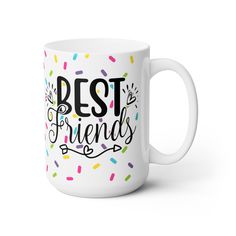 a white coffee mug with the words best friends on it and sprinkles