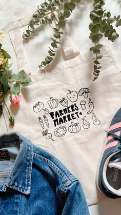 A embroidered Farmers Market design on a organic cotton tote bag. Everyday Cotton Bag With Embroidery, Everyday Embroidered Canvas Tote Bag, Everyday Embroidered Cotton Bag, Embroidered Cotton Everyday Bags, Everyday Cotton Embroidered Bags, Cotton Canvas Tote Bag With Embroidered Logo, Cotton Canvas Bag With Embroidered Logo For Daily Use, Eco-friendly Embroidered Cotton Canvas Bag, Embroidered Cotton Canvas Bag For Daily Use