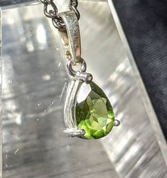 "🌠 GENUINE FACETED TEARDROP MOLDAVITE NECKLACE in 925 Sterling Silver🌠 You will love this Beautiful and ELEGANT Moldavite pendant with Gorgeous natural green colors. Top quality precision faceting highlights this authentic 22mm by 8mm moldavite pendant! Awesome oval shape set in 925 Sterling Silver. It comes with an awesome \"gunmetal\" colored chain (choose your length in the dropdown menu) made in our studio. This will be a treasured go to pendant for years to come. A Shine Crystals top pick Classic Green Teardrop Pendant Necklace, Classic Teardrop Gemstone Necklace, Classic Green Teardrop Pendant Jewelry, Pear-shaped Sterling Silver Birthstone Necklace, Sterling Silver Teardrop Necklace Stamped 925, Sterling Silver Pear-shaped Jewelry For May Birthstone, Sterling Silver Pear-shaped Birthstone Necklace, 925 Stamped Drop Jewelry For Anniversary, May Birthstone Teardrop Pendant Necklace