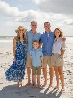 a family poses for a photo on the beach