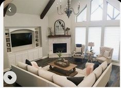 a living room filled with furniture and a flat screen tv mounted on the wall above a fireplace