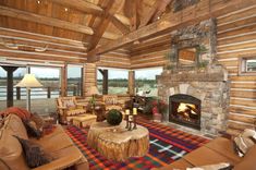 a living room filled with furniture and a fire place in the middle of an open floor plan