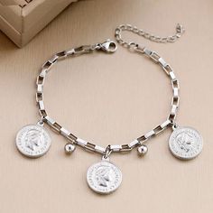 Same Day Shipping to the US Enhance your style with the Queen's Portrait Coin Pendant Charms Bracelet. This stunning bracelet features a secure lobster claw clasp and a sophisticated round shape, adding an elegant touch to any ensemble. Measuring 7.5 inches in length, it is perfect for those with fashionable taste. Elevate your look with this tastefully understated piece that is sure to make a statement. Product Details Clasp Type: Lobster-claw-claspsShape\pattern: RoundSetting Type: NoneFine or Lobster Claws, Digital Gift Card, Digital Gifts, Timeless Accessories, Coin Pendant, Exquisite Jewelry, Sophisticated Style, Silver Bracelets, Silver Color