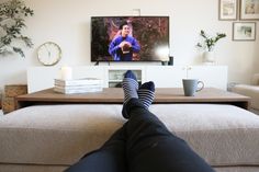 a person sitting on a couch watching tv