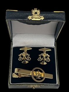 A stunning set of Legal Scales of Justice Cufflinks and Tie Clip lavished in 24k Gold LAW GOLD  CUFFLINK SET Very high quality set of cufflinks -  - A very nice weight, super detail and crafted to last indefinitely. The detail is beautiful. LAW TIE CLIP As with the cufflinks, this exquisite tie clip has been stripped to the base metal and lavished in multiple layers of certified 24k gold. Sealed and polished. Includes detailed hand signed and dated certificate pertaining to the gold plating. The certificate is housed in a gold envelope.  Presented in a beautiful, luxurious double gift case with metal fittings and press-button brass clasp and corners, British Gold Company branded and double boxed. Shipped within 24 hours insured and tracked delivery to your door  PLEASE NOTE: Shipping costs Luxury Gold Clip-on Cufflinks, Luxury Gold Suit And Tie Accessories For Formal Occasion, Luxury Formal Gold Sets, Classic Gold Sets For Business, Classic Gold Sets For Formal Occasions, Classic Gold Formal Sets, Gold Jewelry With Gift Box For Father's Day, Elegant Silver Sets For Gift, Elegant Silver Sets For Gifts