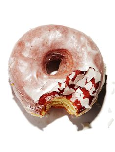 a glazed donut with white frosting and red sprinkles