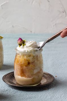 two jars filled with food sitting on top of a blue table covered in white frosting