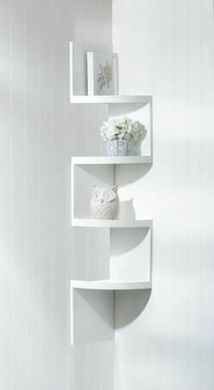 three white shelves with flowers and pictures on them