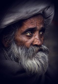 an old man with a long beard wearing a hat