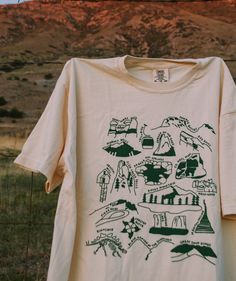 Our tribute to the nature in Colorado! This design features all 4 national parks and 15+ other beautiful spots from Grand Junction to Denver. Let it remind you of the places you've been and inspire you to see the rest! This item will ship within 1-2 business days of ordering. If combined with a made-to-order item, we will default to shipping when your entire order is ready This listing has a measurement chart (please scroll through the photos); you can also reference any reviews and our page on National Parks Tshirt, Nature T-shirt, National Parks Shirt, Outdoor Graphic Tees, Nature T Shirt, Adventure Tshirt Design, Travel T Shirt, Granola Shirts, Nature Shirt Design