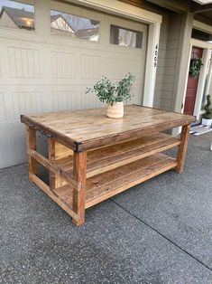 a table made out of pallet wood with a potted plant sitting on top