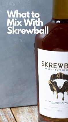 a bottle of skrewball wine sitting on top of a wooden table with the words what to mix with skrewball