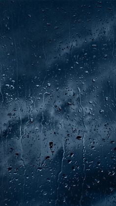 rain drops on the window and dark blue sky