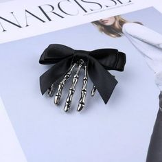 Description: Name: Bowknot Skull Ghost Claw Hair Clip Material: alloy fabric Size: 4.5x5cm Shape: ghost hand Style: Women's Package Included:1x Bowknot Skull Ghost Claw Hair Clip Notes: 1. Due to the different monitor and light effect, the actual color of the item might be slightly different from the color showed on the pictures. Thank you! 2. Please allow 0.1-2cm measuring deviation due to manual measurement. Size: one size.  Color: Black.  Gender: female.  Age Group: adult. Skeleton Ghost, Gothic Hairstyles, Self Defense Keychain, Metal Skull, Punk Accessories, Halloween Bows, Skull Hand, Gothic Accessories, Claw Hair Clips