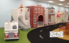 children's play area with firetruck, slide and toy houses on the floor