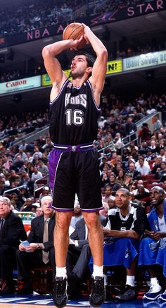 a basketball player is getting ready to dunk the ball in front of an audience