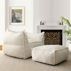 a living room filled with furniture and a fire place next to a wall mounted fireplace