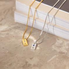 Pretty, dainty and totally adorable! The Mini Birthstone Initial Tag Necklace is just what your jewelry collection needs. A contemporary update to the classic monogram necklace, personalize it with the first letter of your name or add a birthstone to the pendant to for a little extra sparkle. The small, understated design makes this necklace fun and flirty, perfect for everyday wear. Material: High Quality Solid 925 Sterling Silver, CZ Birthstones Finish: Sterling Silver ∙ 18K Gold ∙ Rose Gold F Dainty Everyday Initial Necklace With Birthstone, Modern Sterling Silver Personalized Charm Necklaces, Dainty Birthstone Name Necklace For Everyday, Silver Dainty Name Necklace With Birthstone, Silver Initial Necklace With Name For Her, Minimalist Everyday Initial Necklace With Birthstone, Modern Personalized Sterling Silver Charm Necklaces, Dainty Sterling Silver Name Necklace With Birthstone, Dainty Birthstone Name Necklace