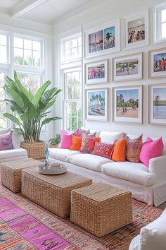 a living room filled with lots of furniture and pictures on the wall above it's windows