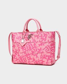 Make a bold statement with the Pink Graffiti Tote Bag, a playful and eye-catching accessory that's perfect for adding a pop of color to any outfit. This stylish tote features a vibrant pink color and a striking graffiti print, adding a touch of urban edge to any ensemble. The woven construction and double handles provide both style and functionality, while the spacious interior offers plenty of room for your essentials. Trendy Double Handle Bags With Logo, Trendy Logo Shoulder Bag For Daily Use, Trendy Shoulder Bag With Logo For Daily Use, Trendy Logo Shoulder Bag, Designer Rectangular Streetwear Bag, Trendy Pink Shoulder Bag With Letter Print, Trendy Pink Shoulder Bag With Logo, Designer Pink Bag With Logo, Pink Letter Print Bag For Shopping