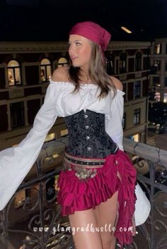 a woman in a corset is standing on a balcony